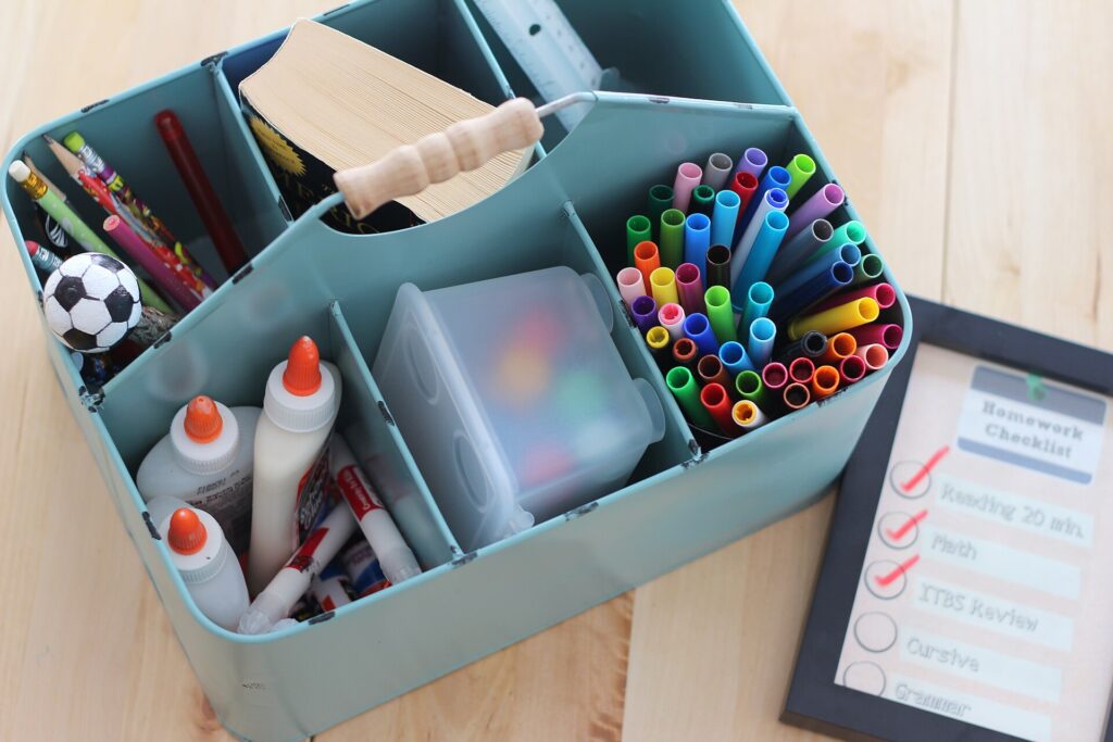 This file is licensed under the Creative Commons Attribution 2.0 Generic license. Attribution: Personal Creations. Source https://commons.wikimedia.org/wiki/File:Tote_organizer_with_glue_pens_pencils_chalk_and_checklist_(21312803141).jpg